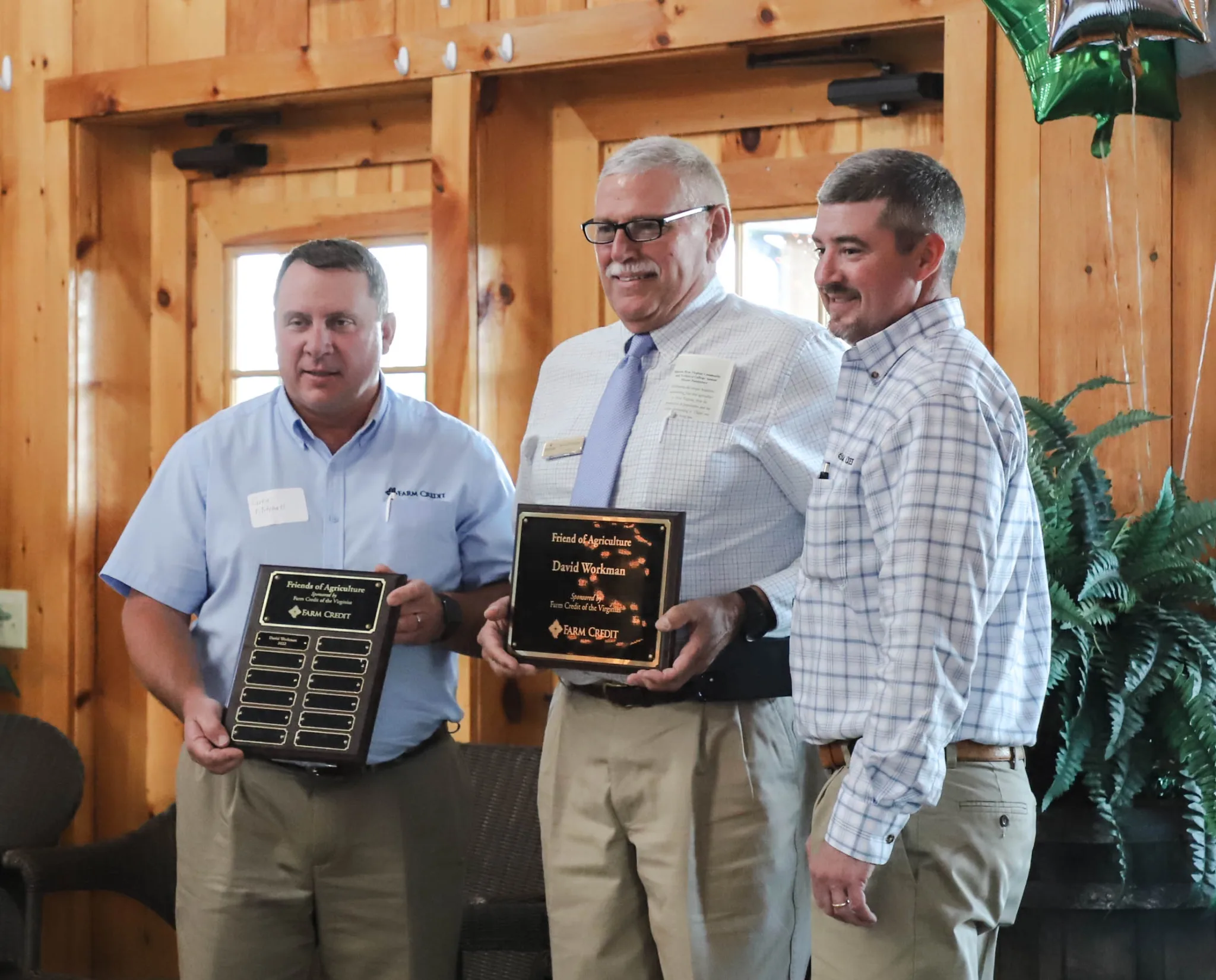 David Workman (center) stands with Greg Mitchell and Trey Keyser of Farm Credit of the Virginias after Workman received the Friend of Agriculture award.