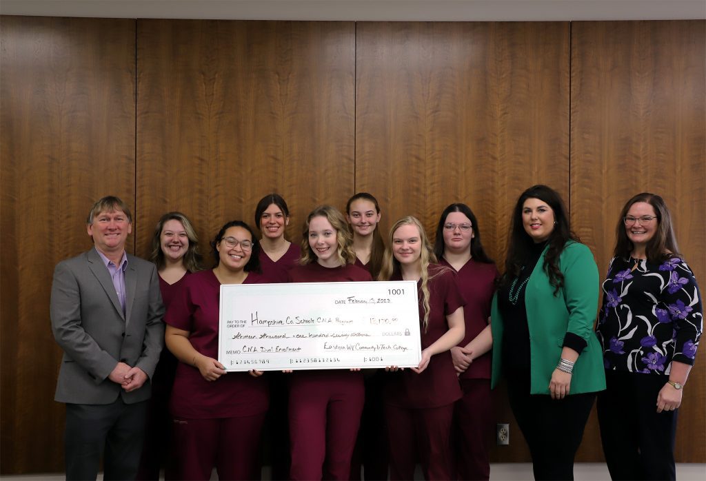 College leadership presenting check to local high school