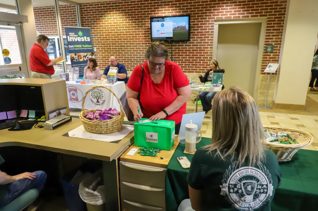 Woman entering a ticket into a drawing