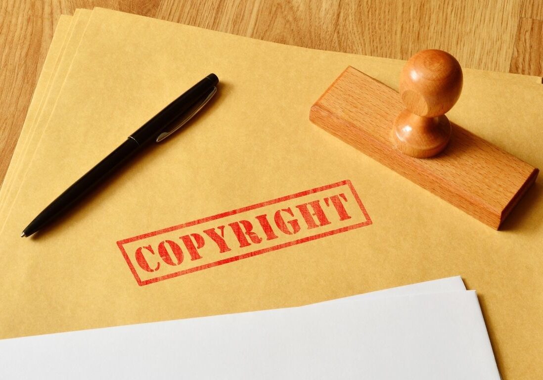 Photo of a file with 'Copyright" stamped on it. The stamp and a pen are also on the folder.