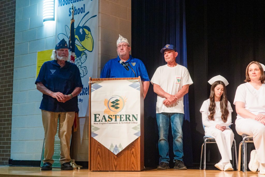 Photo of representatives from 40 & 8 Hardy County Voiture 1623 speaking at podium.